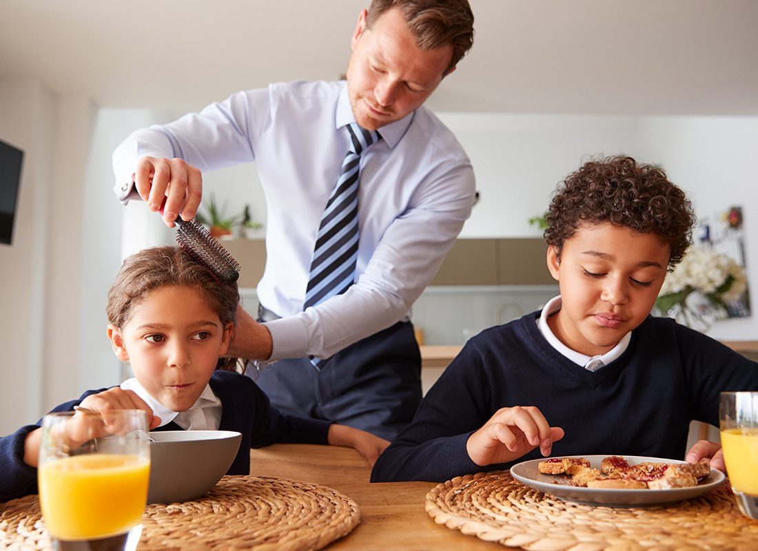 Personal Insurance - Father and Children Getting Ready for the Day and Having Breakfast in the Kitchen